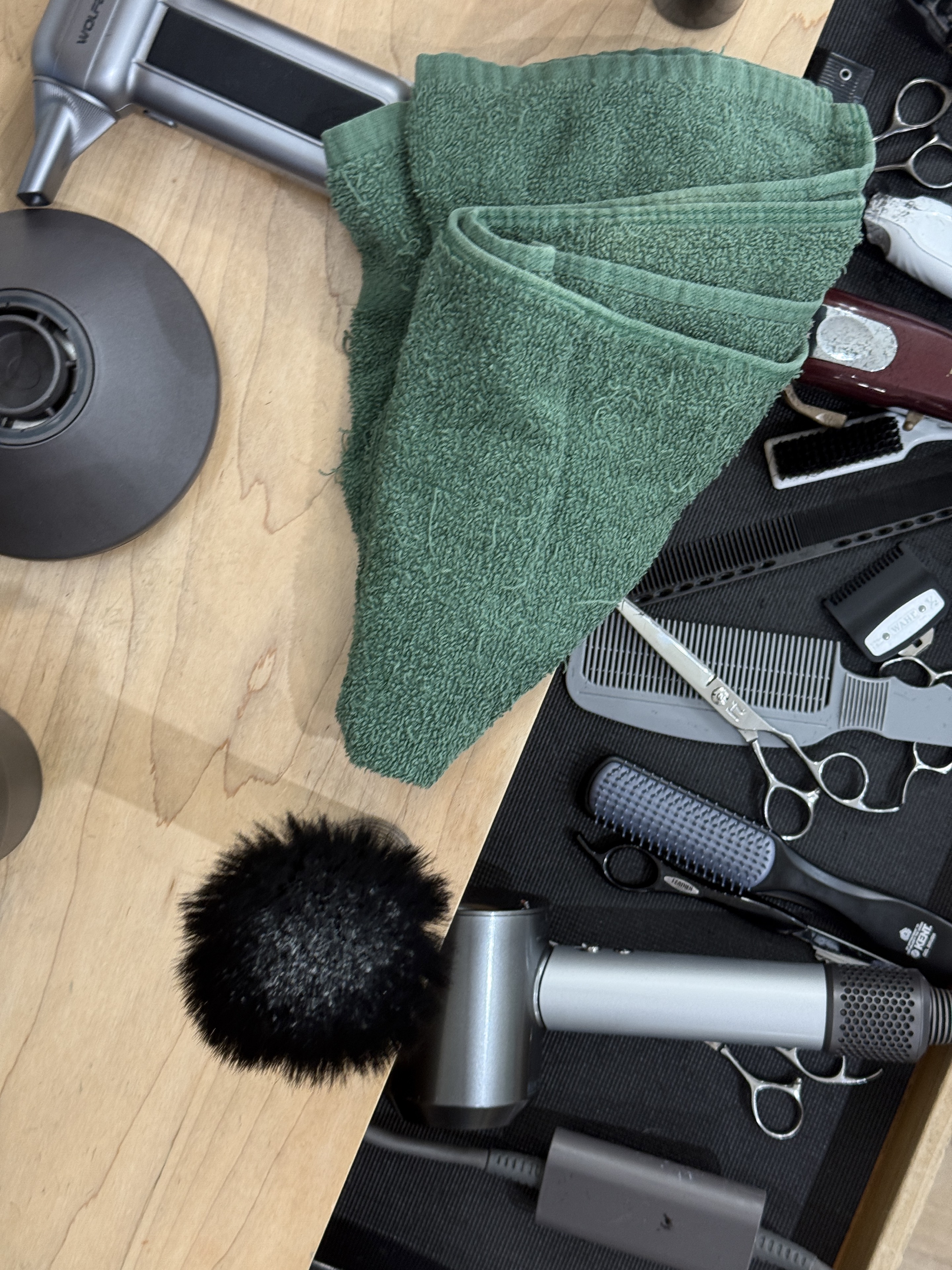 Barber tools arranged with towel and combs