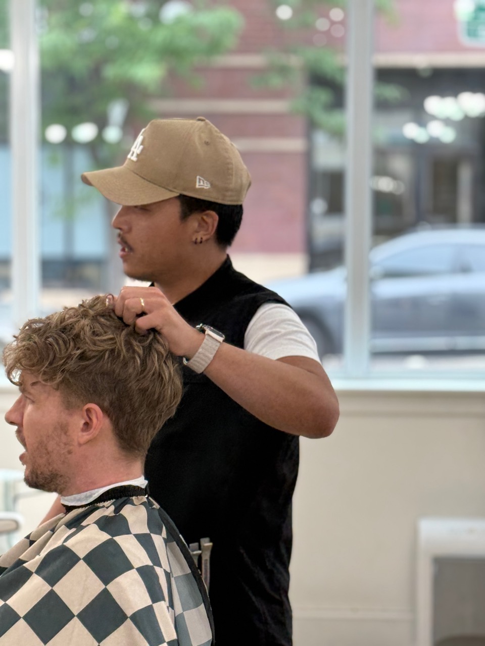 Side profile of Daniel shaping a client's haircut.